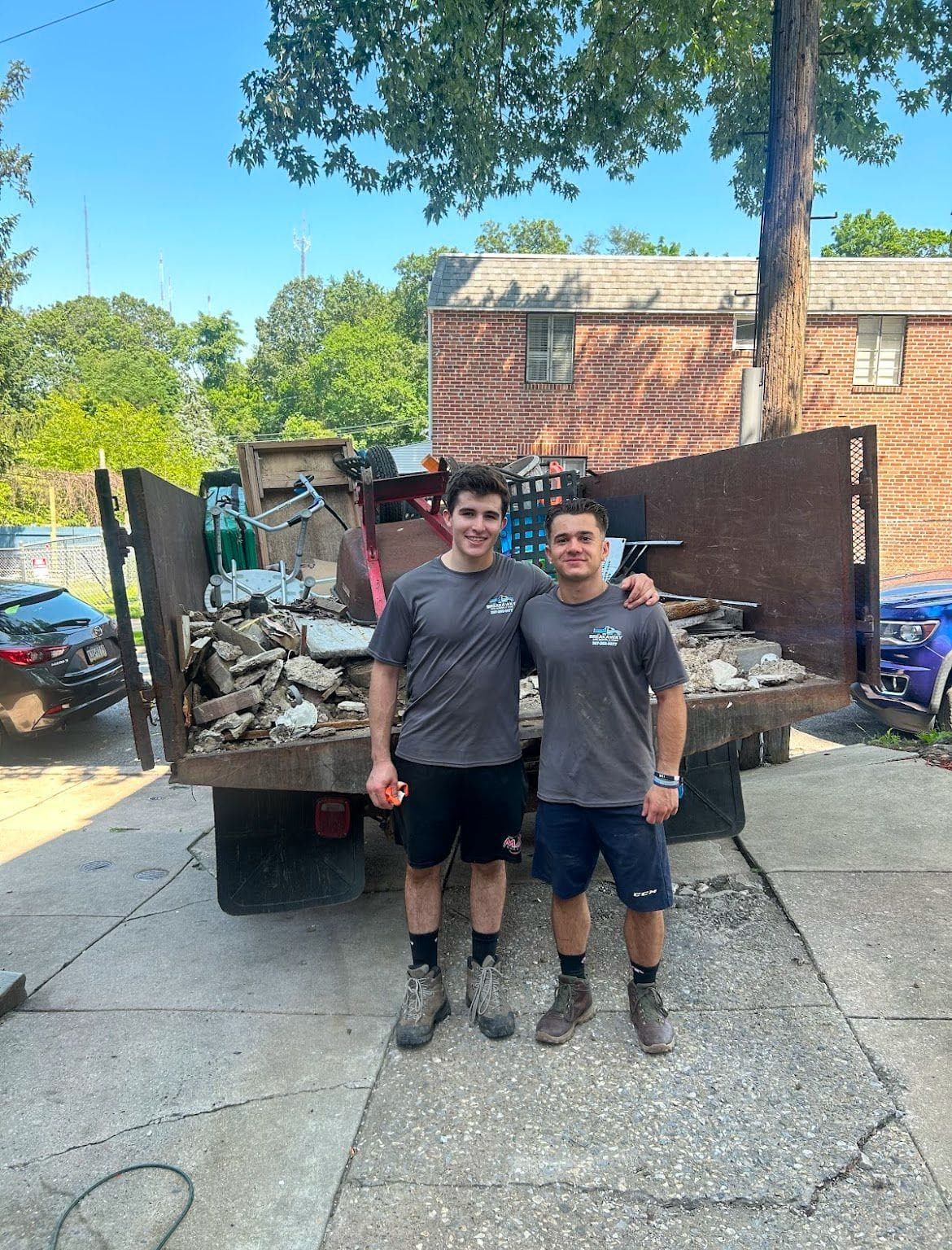 Two Breakaway crew members in front of a fully loaded trailer