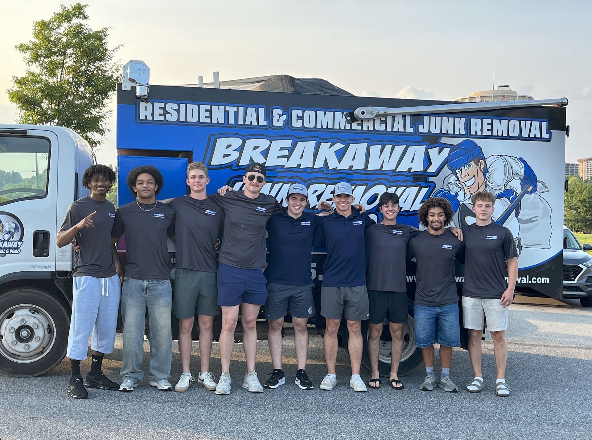 The Breakaway crew lined up in front of their branded junk removal truck