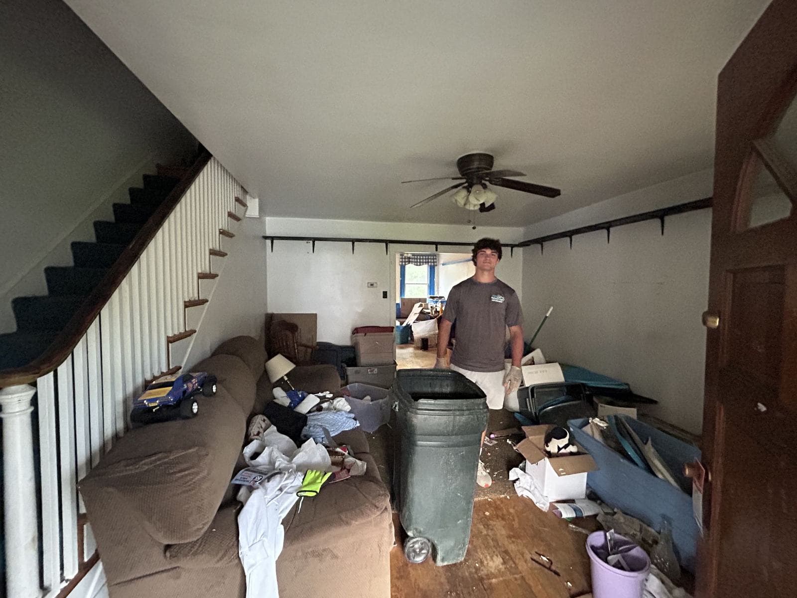 A cluttered living room before a cleanout
